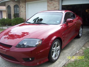 Hyundai Tiburon - What I drive now! - It used to be owned by a young guy who made it very loud! But it's got a sunroof and a fantastic stereo system (By the way, Tiburon means shark in Spanish)