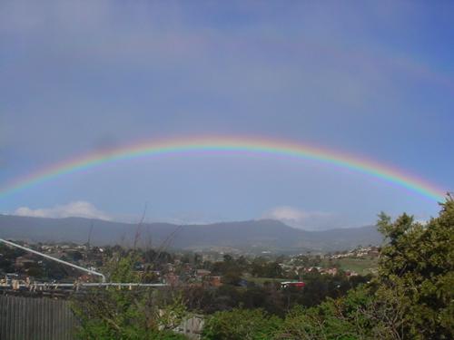 Some where over the rainbow  - It was a cold yucky day when the skies broke and well you can  imagine my surprise when out my back door I saw this beautiful rainbow.. just had to run for my camera. Sometime's one just has to wait for the storm to pass before seeing the beauty