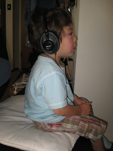 Weary Music - A weary kid listening to music through a headphone.