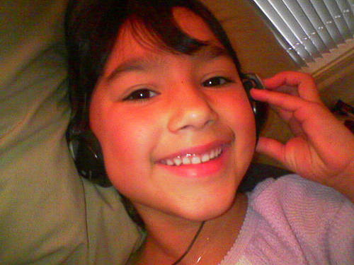 That Smile is Music - A cute little girl showing her adorable smile while listening to music.