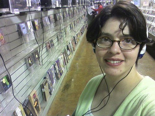 Smile for the Music Store - A lady showing off her smile while listening to music at a music store.