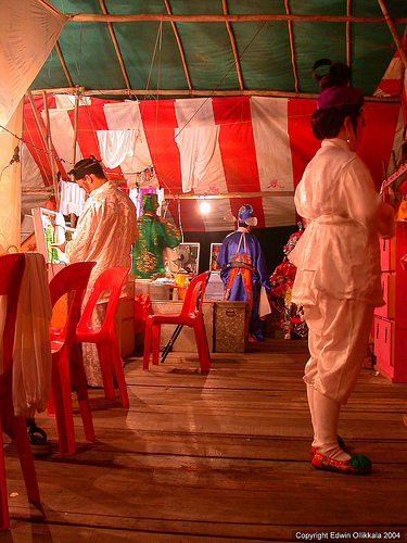 Backstage - they are dressing and making up preparing for the show.