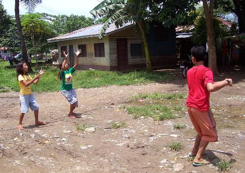 Sha~tong - A few kids playing a local game called 'shatong.'   I wish I could explain more about the game, but I don't understand it either.