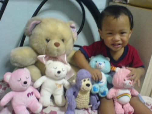 dreu and my toys - this is a picture of my stuff toys with my cute nephew, drew. he used to play with my toys in my room. it's so fun watching him. 