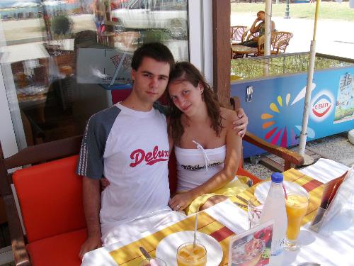 Me and my girl at a restaurant in Greece - Me and my girl at a restaurant in Greece this summer while we were spending our vacation. It was my first trip abroad and i quite enjoyed it. If you look closely in the window there you can actually see the sea. The orange juice was quite expensive - 4 Euro.