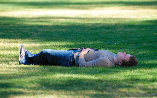 Taking a Time-Out - A guy relaxing outside while listening to music.