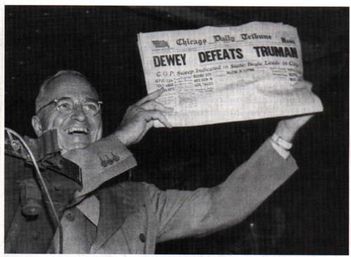 Dewey Defeat Truman - President Truman holds up newspaper proclaiming his opponent the winner