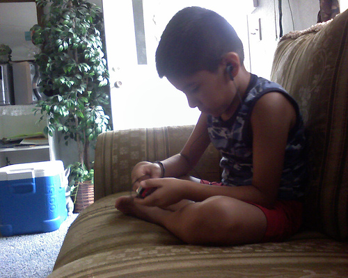 Kid's Music - A lonely kid listening to music.