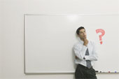 Thinking - Man in front of ry Erase Board thinking