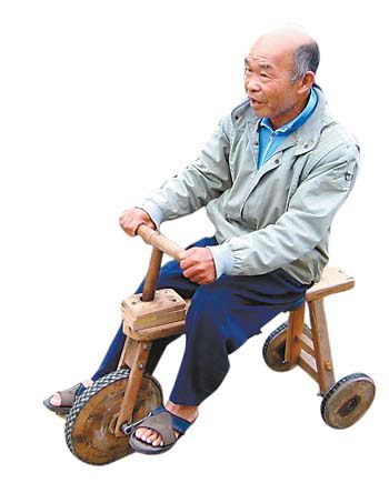 an old Chinese man riding on his own wooden bike  - whenever he rides on the street, he is followed by some kids running all the way after him for amusement. The kids are interested in his wooden bike. So am I. Here is the photo for you to have a look at the old man in his eighties riding on his wooden bike. 