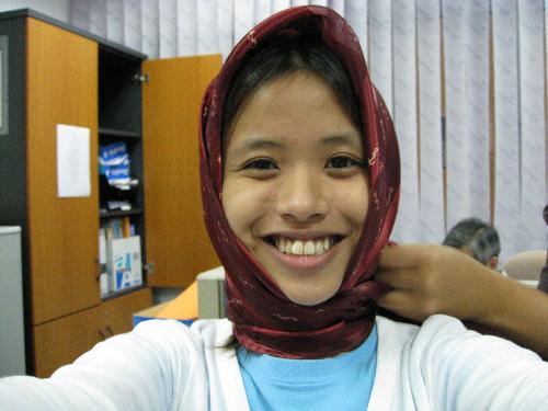 Me in A Shawl! - I am in the office trying to act funny. That is my colleague's scarf wrapped up around my head as if I am wearing a tudong. It was done just for laughs. Ain't I cute?