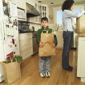 grocery shopping - Son helping mom unload groceries