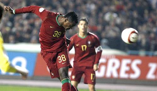Nani - nani with a header while Cristiano Ronaldo watches the ball going toward the nets.