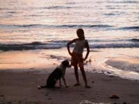 beach - This is again one of my first try in photography. I love this hobby. I thank an FFL(friend for life) for giving me a digital camera to use for taking pictures. The model is my eldest daughter and our pet dog. This is just taken at the back of our house. I love the sunset here.