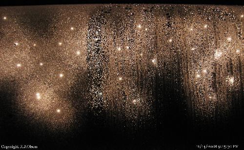 Night Lights - My icicle lights outdoors from inside of my  screen door with moisture all over the glass.