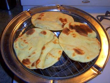 grilled naan - Naan, one kind of Indian bread making on grill