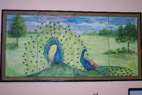 Hand painted by my friend, Mary, on silk on a fold - Bought this old silk screen folding hanging thing at an auction. It had a horrible design painted on the silk, but the silk brocade surrounding the frame is in perfect shape. Asked my very talented friend, Mary, who will showcase her artwork in my online gallery, Purple Haze Creations, as soon as it is up and running, if she would paint me a peacock on it. To my blissful surprise, she gives me two of them, in all of their majestic beauty. This painting is huge and covers the entire wall above my 'Peacock' couch.  Can you say, 'She's a little obsessive compulsive?' Yes, I am, and I love it.
