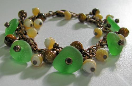 Green Sea Glass and Shell Bracelet - This antiqued copper bracelet is adorned with five pieces of green sea glass, and polished shell beads in brown and creamy beige colors. Finished with a lobster clasp. Available in my shop on Etsy
