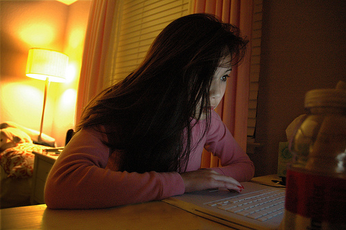 Computer Addict - A snapshot of a woman addicted to computer. She looks like a computer zombie.