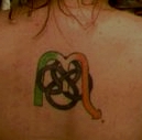 my Irish tattoo - The Scorpio rune/symbol in green, white, and orange, entwined with a Celtic knot