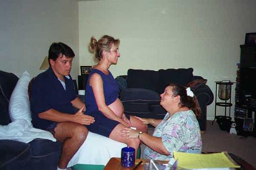 Doula - Cindi Howard Castle is the Doula in this photo, helping a expectant mom through a contraction (along with the husband) during labor at couple's home. Just moments later they all three left for the hospital for a very fast delivery of a healthy baby girl.