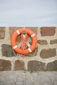 Life - Life ring hanging on a brick wall