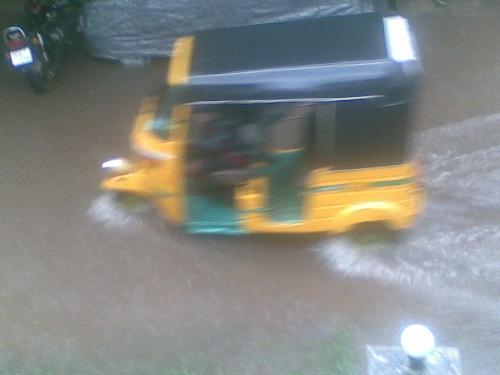 Water logging in the streets - An auto rickshaw wading through a water logged street in Anna Nagar in Chennai