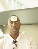 Questions - Business man with a question mark postie on his forehead