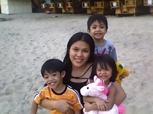 My eldest daughter elisa and her son miguel and tw - they are enjoying the white sand in the beach