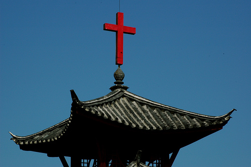 Religion in China - A photo showing a religious symbol which is the Christianity's cross attached to a building in China.