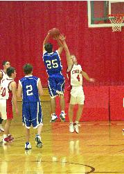 Basketball game using the Minolta A1 - This showes what you can do with the proconsumer system.  You can still get very good action shots.  I was at the far end of the cort when I took this photo.  This photo was cropped (aboutr 1/2 of original picture) and enhanced in Photoshop to correct the lighting - the gym had floressent blue/yellow lights and gave everything a slight oreng tint.  Photo shop was able to correct most of it.  The crop was to a 5x7 photo for a parent and it turned out great