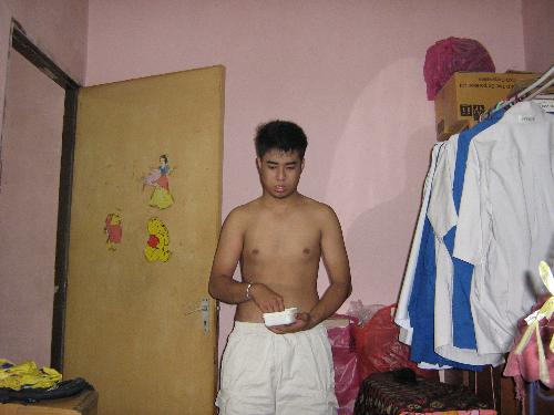 Entity Photo 03 - The guy is Hafizuddin. He was reciting certain Quranic verses in an attempt to get rid of the entity. His younger brother, who was sitting on the bed, had goosebumps and a creepy feeling. He did not see anything but pressed on the shutter.
