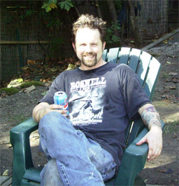 Me relaxing - Sitting in my yard, enjoying a soda, after working on the roof