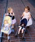 Two children walking strollers - Two children walking strollers.
