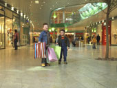 Shopping - Picture of young boys holding the shopping bags in the mall