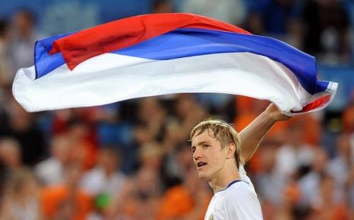 Pavlyuchenko With Flag - Roman Pavlyuchenko of the Russian national team waves the Russian flag about after their 3-1 victory against the Netherlands in the quarterfinal of the Euro 2008 match. Pavlyuchenko, Torbinski, and Arshavin were the Russian goalscorers, with Van Nilsterooy on the opposing side.  The Russian team was eventually defeated 3-0 in the semifinals, the next stage of the competition, against Spain.