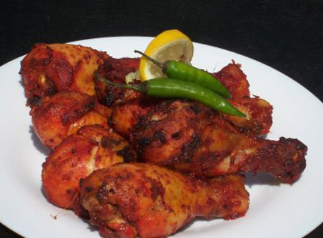 Tandoori Chicken - Tandoori Chicken is a semi-fried chicken delicacy that originated in the Punjab region of the Indian subcontinent.