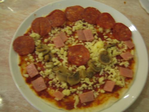 Smiley Pizza - Its a pizza that was prepared and decorated by my son with the help of his auntie (my sister) before it was cooked in the oven.