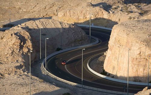 Hafit mountain - The road is cut into the Jebel Hafeet mountain, the highest peak in the United Arab Emirates , the oil-rich Persian Gulf state. The mountain spans the border with Oman and lies about 90 minutes' drive southeast of the thriving city of Dubai . It looks down upon a dusty, desert landscape that belies a nation of astonishing wealth.