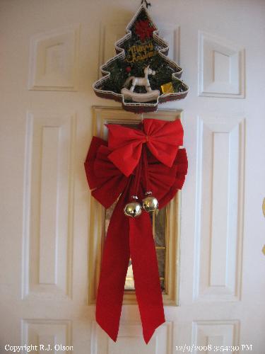 Front Door - Bows and Jingle Bells for the Holiday Season.