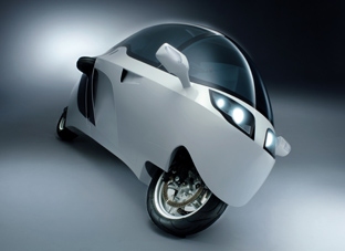 Monotracer - The Peraves Monotracer is a fully enclosed motorbike featuring a sporty, aerodynamic appearance and low fuel consumption. The Peraves Monotracer is a new, updated and more attractive version of the Swiss-made Ecomobile. The Peraves Monotracer consists of a Self-supporting composite-monocoque made from glass, kevlar and carbon tissues bonded by epoxy-resin reinforced with crash and roll bars. The Engine frame, steering and head and stabilizer axles are made from aircraft grade alloy steel. The suspension is handled by Marzocchi 50mm USD-forks up front and at the rear a Monolever shaft swingarm. Entry is a via Gull-wing-door with integrated sunroof, opening to the left. The real beauty of the Monotracer is its ability to combine the benefits of both motorcycles and sports cars. The Monotracer can lean like a bike, but a low speeds or when undergoing steep angle turns, small wheels normally recessed in the body lower themselves to provide stability. Inside the Peraves Monotracer there is rom for two people seated in tandem. The seats are RECARO-contour-seats with 3-point, automatic-safety belts, and the driver and passenger can enjoy the benefits of a GPS and audio system. Power of the Peraves Monotracer comes from a BMW K 1200 sourced engine developing 130 horsepower, this is connected to a 4 speed transmission with reverse