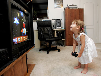 video games - girl playing video a game.