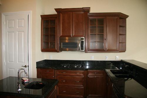 microwave - This is the kitchen photo of the model house. You can see the microwave at the top of the stove.