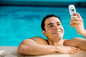 cell phone - photo of Close-up of a young man holding a mobile phone