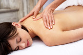 massage therapy - photo of Young woman receiving massage therapy
