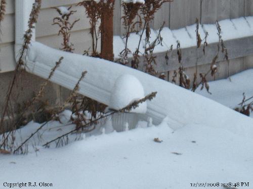 Wind blown snow - Snow blown onto my gutter and solar light.