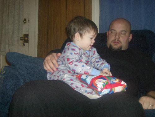 Baby's first Gift - My youngest with his dad opening a gift for Christmas
