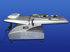 EECP MACHINE - Treatment Bed With Cuffs - [EECP] - [EECP(ECP) or Enhanced External Counter Pulsation is a modern machine designed in USA and approved by USDFA for treatment of heart disease arteries. It increases blood flow to the diseased arteries by 200% and opens up collaterals. Thus it relieves chest pain and difficulty in breathing. The patient can walk longer, breathe easier and have a much better quality of life. The five year survival rate is the same for surgery, stents and EECP(ECP).] - [Who can benefit from EECP(ECP) ? - Those who have been advised bypass surgery and choose not to have it.] - [Those who cannot afford the cost of bypass surgery.] - [Those who have other diseases which make them unfit for surgery eg. coexisting Diabetes Mellitus, Bronchial Asthma, Kidney failure, Thyroid disorders, old age i.e. more than 80 yrs.  Those who have already had bypass surgery done a few years earlier and don't want to suffer the experience again.] - [Those patients who cannot afford the exorbitant cost of angioplasty (upto Rs 3.75 lacs with two cipher stents and reopro).] - [Those patients who have chest pain or breathlessness of cardiac origin and do not wish to undergo any further investigation can go for EECP(ECP) directly.  Patients whose stents have got blocked again.] - [How does EECP(ECP) work?] - [Actually it is quite simple. The patient lies comfortably on a couch in an A/c room. The legs, thighs and buttocks are enclosed in rubber bladders like those in a BP cuff. Three electrodes are placed on the chest wall to monitor the heart rhythm. One sensor is placed on the index finger or earlobe to monitor the pulse wave. The machine is then started and it sends pressure waves to the air bladders synchronized with the heart beats in such a way that when the heart contracts, a negative pressure wave is sent through the legs so the blood meets with very little resistance. When the heart relaxes (during diastole) positive pressure waves send the blood back to the heart in a more effective manner. So the coronary perfusion is increased by 200%.This causes the collapsed collaterals to reopen and provide blood to areas starved of oxygen.] - [In brief EECP(ECP) results in; Increased diastolic perfusion pressure, Increased coronary perfusion, Increased coronary collateral flow to ischemic regions of myocardium, Decreased ventricular load, Increased venous return.] - [How does the patient know it benefits him ?  Patient starts feeling better in 3-5 days.His chest pain become less & his difficulty in breathing becomes better.] - [He can walk longer distances without onset of chest pain. His daily need of sub lingual nitrite tablets (sorbitrate or GTN) reduces dramatically.] - [TMT or exercise test is done before and after EECP(ECP). The ST segment depression seen before is markedly decreased eg. a 2-3mm ST depression can easily become 0.5-1mm after 35 days of EECP(ECP). The patient who could exercise say 4mins on the treadmill earlier can now exercise 10 mins without onset of chest pain or breathlessness.] - [Echocardiography is done before and after EECP(ECP). Ejection fraction or the efficiency of the heart improves from say 25% to 40% after 35 days of treatment.] - [There may be visible improvement in the ECG in the form of heart rate, ST segment depression & ectopics.] - [Stress thallium done before and after shows improved perfusion i.e. blood flow can be seen in those areas of the heart which were earlier starved of blood. Thus we see a marked improvement in almost all parameters of cardiac function measured before and after EECP(ECP).] - [So the good effects of EECP(ECP) can not only be felt by the patient but can also be demonstrated to his relatives and his treating Physician.] - [Cost of treatment (comparison) - EECP(ECP) is available in the most advanced Medical Cardiac centers like; The Cleveland Clinic, John Hopkins Medical center, Texas Heart Institute, The Mayo Clinic, JKF Medical Center Atlantis, BIMC New York city, University of California San Diego.] - [In London the cost is $12,000 and the waiting list is huge ref. The Sunday Express dtd. March 7th 2004  In Randhawa Hospital Amritsar, the total package cost is $ 2,500 only This includes 35 1hr EECP(ECP) sittings + complete blood tests including lipid profile, TMT test, and ECHO done before and after EECP(ECP).] - [Arrangement for accommodation can be made within the hospital @ US$ 30/day AC, @ US$ 50/Day in 3 Star Hotel within 800 Meters of the Hospital or @ US$ 70/Day in 4 Star Hotel within 2km]