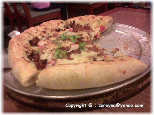 Thai seafood Pizza - With soft melted mozzarella string cheese rolled into the light garlic-finished crust.You can eat it backwards!