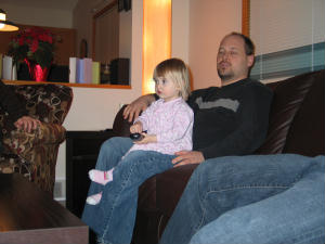 My Older Son teachng Katie how to use the remote - My older son and my granddaughter Katie New Years Eve 2008 at my younger son's place. They are both sports addicts